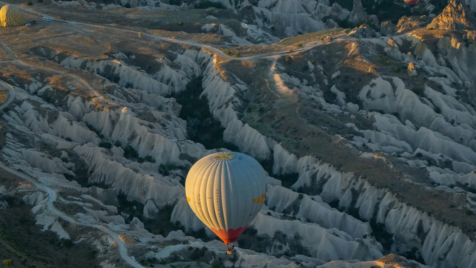 Hot air balloons at sunrise over the valleys of Uçhisar, Cappadocia